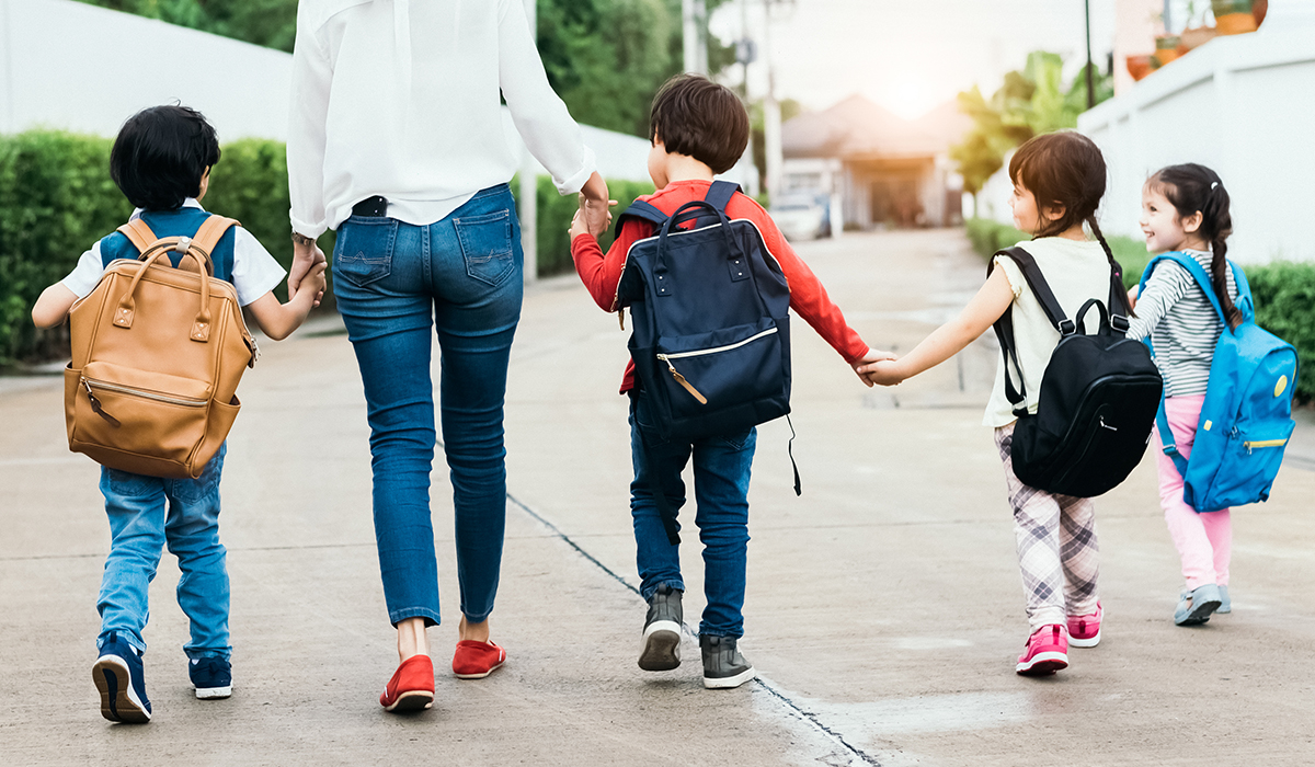 A group of children going to school, holding hands