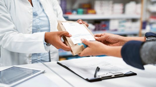 A pharmacist assisting a customer