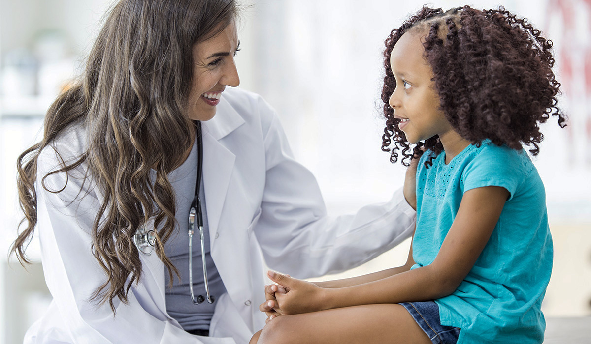 A doctor speaking to a young girl
