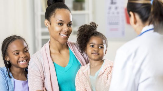 Smiling family speaking to a doctor