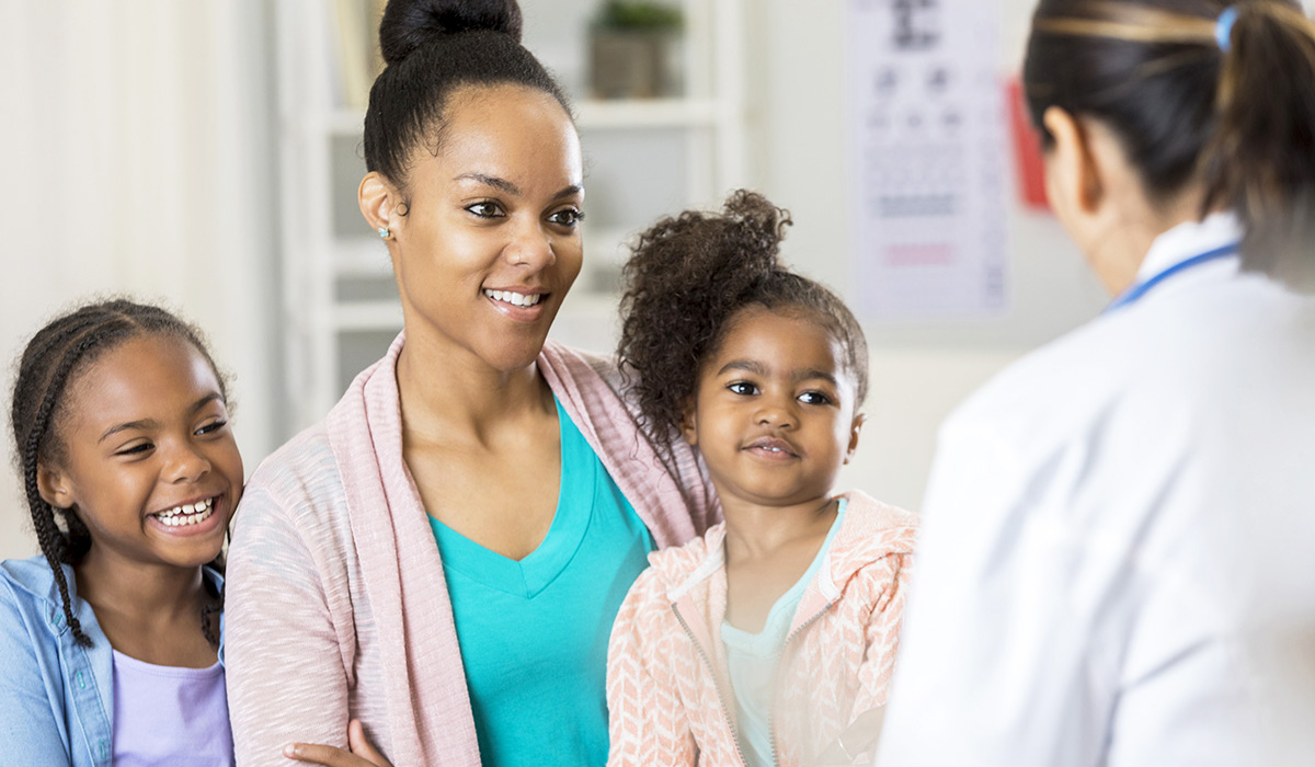Smiling family speaking to a doctor