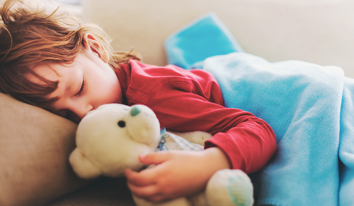 A child napping with a teddybear