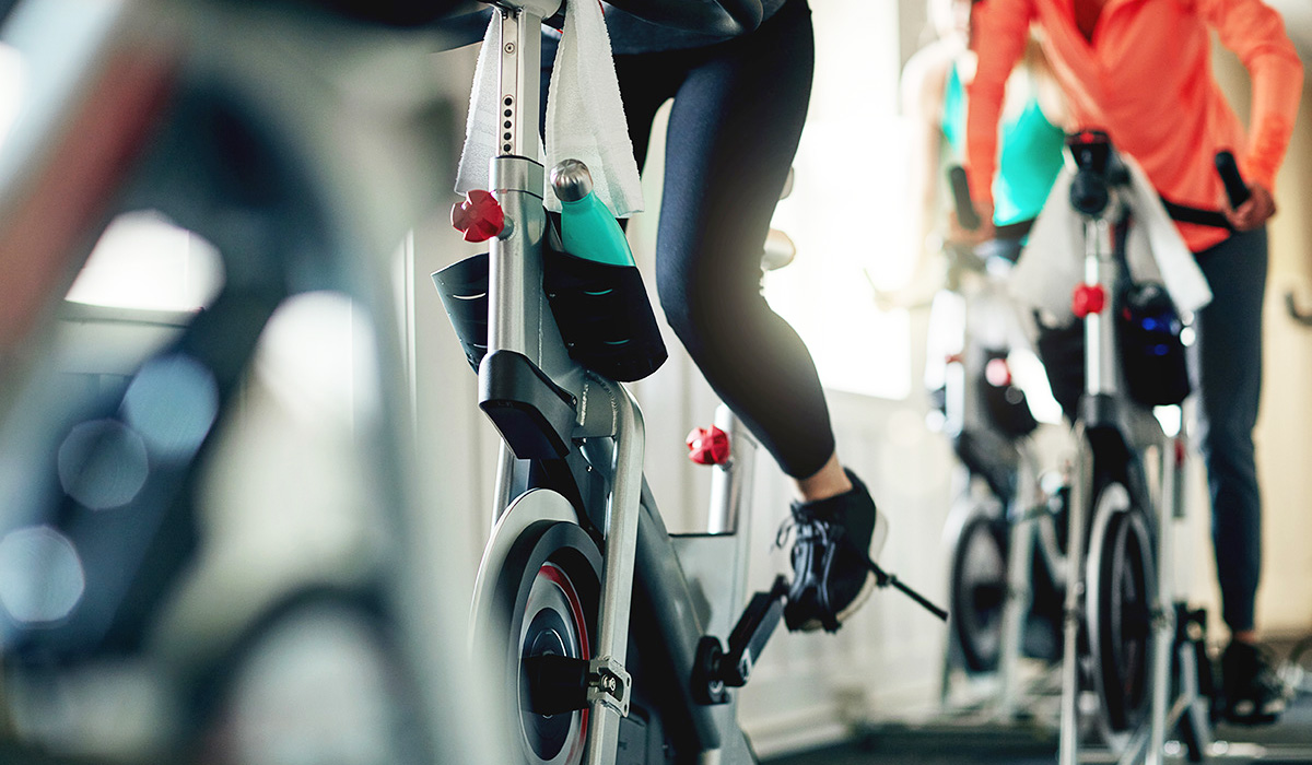 People performing indoor cycling exercises