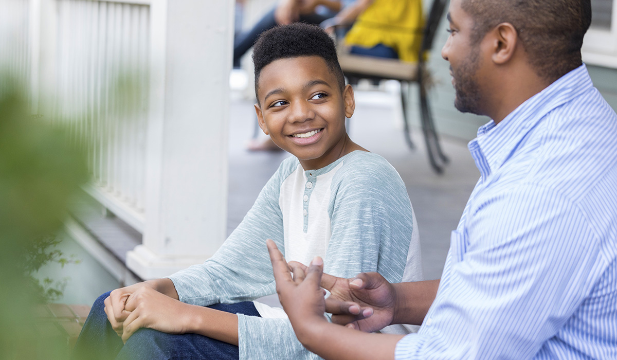 A father and young son having a conversation