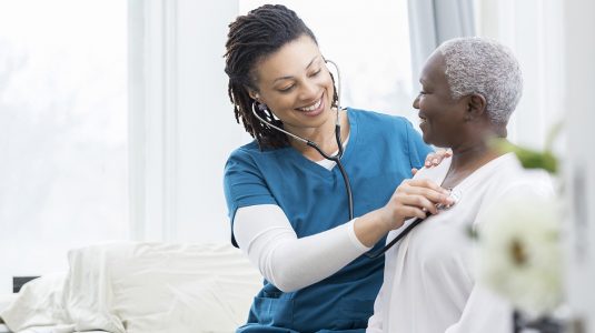 A nurse checking on her patient