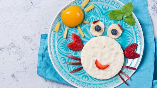Rice waffles with yogurt in the shape of a crab with fresh fruits prepared for kids
