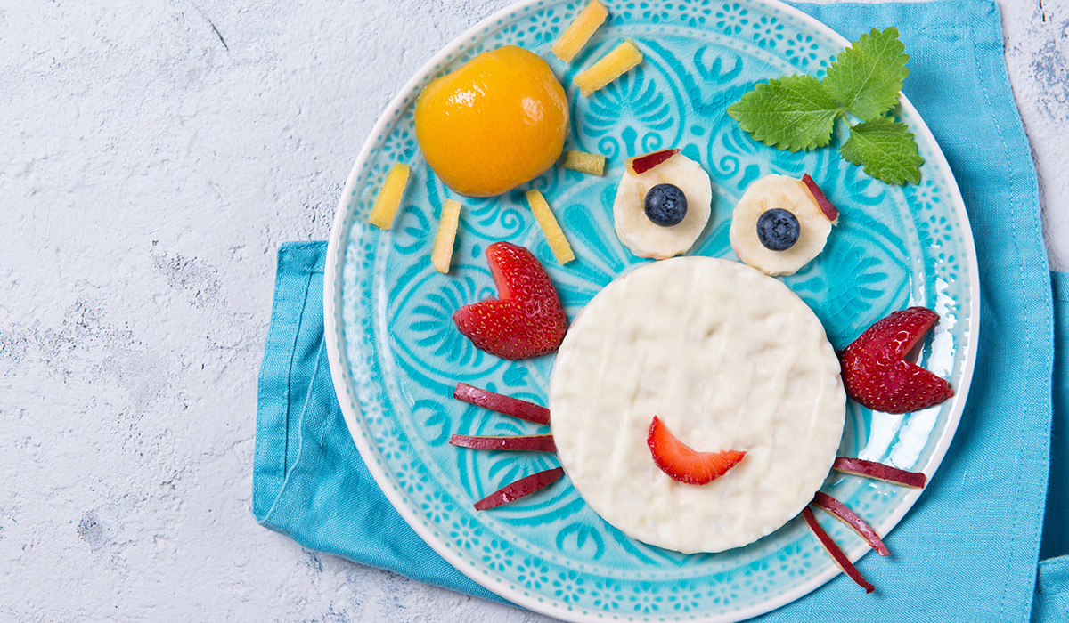 Rice waffles with yogurt in the shape of a crab with fresh fruits prepared for kids
