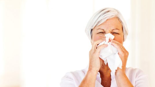 A person blowing her nose