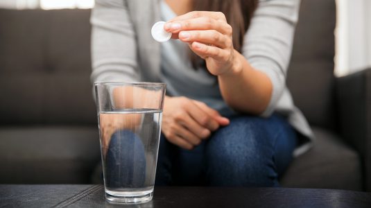 A person about to take an effervescent antacid.