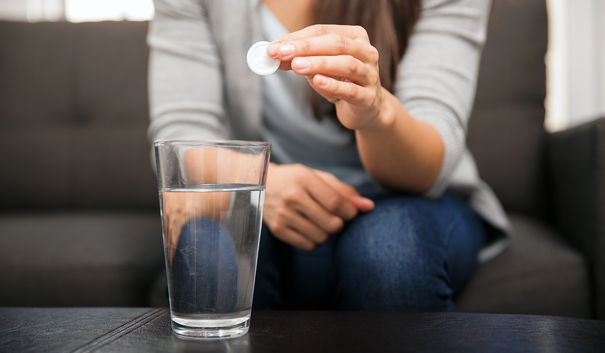 A person about to take an effervescent antacid.