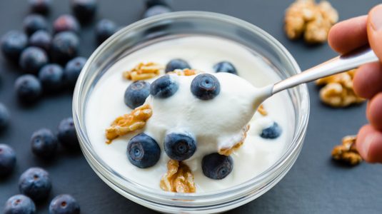 A spoonful of yogurt with blueberries