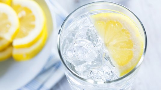 Glass of iced water with lemon