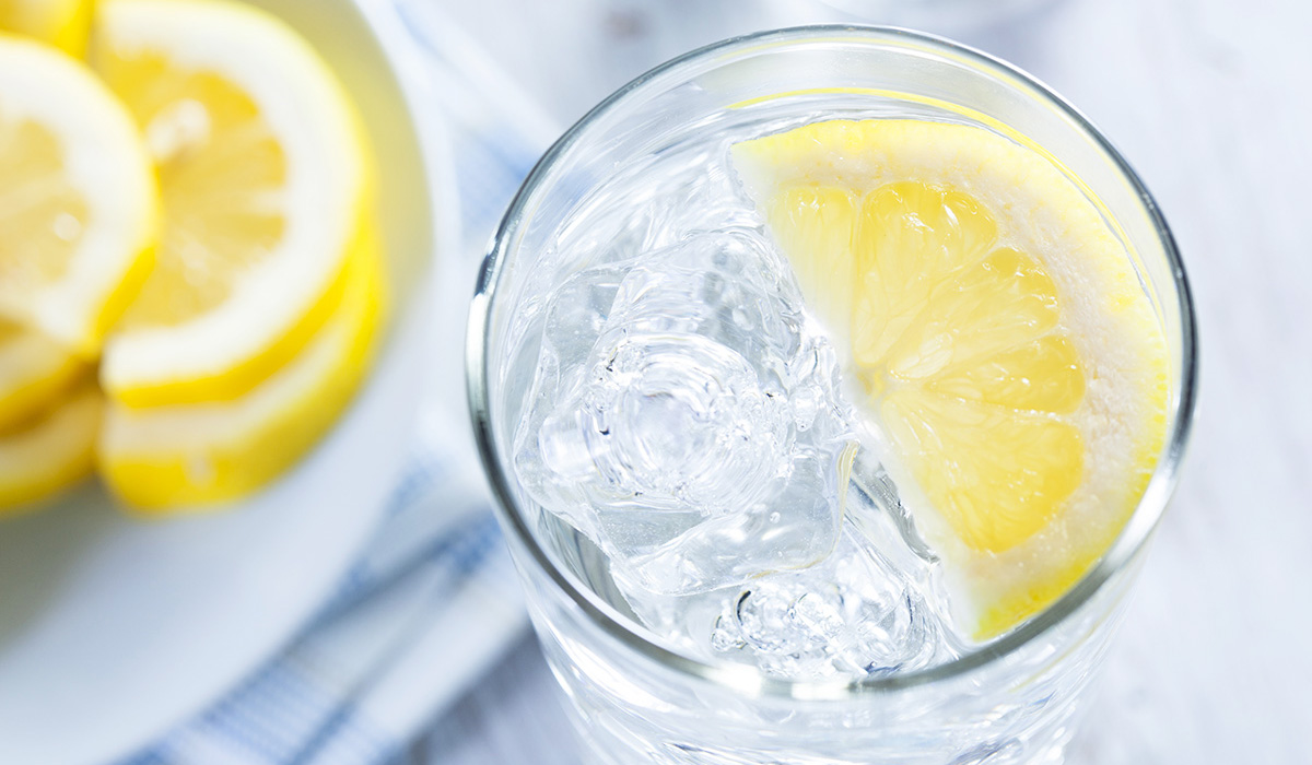 Glass of iced water with lemon