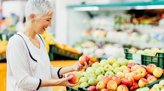 A woman shopping for fruits at a supermarket