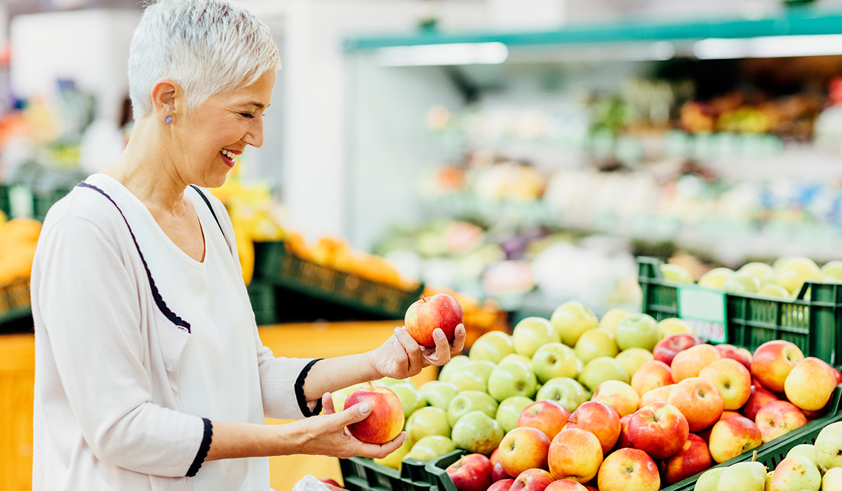 A woman shopping for fruits at a supermarket