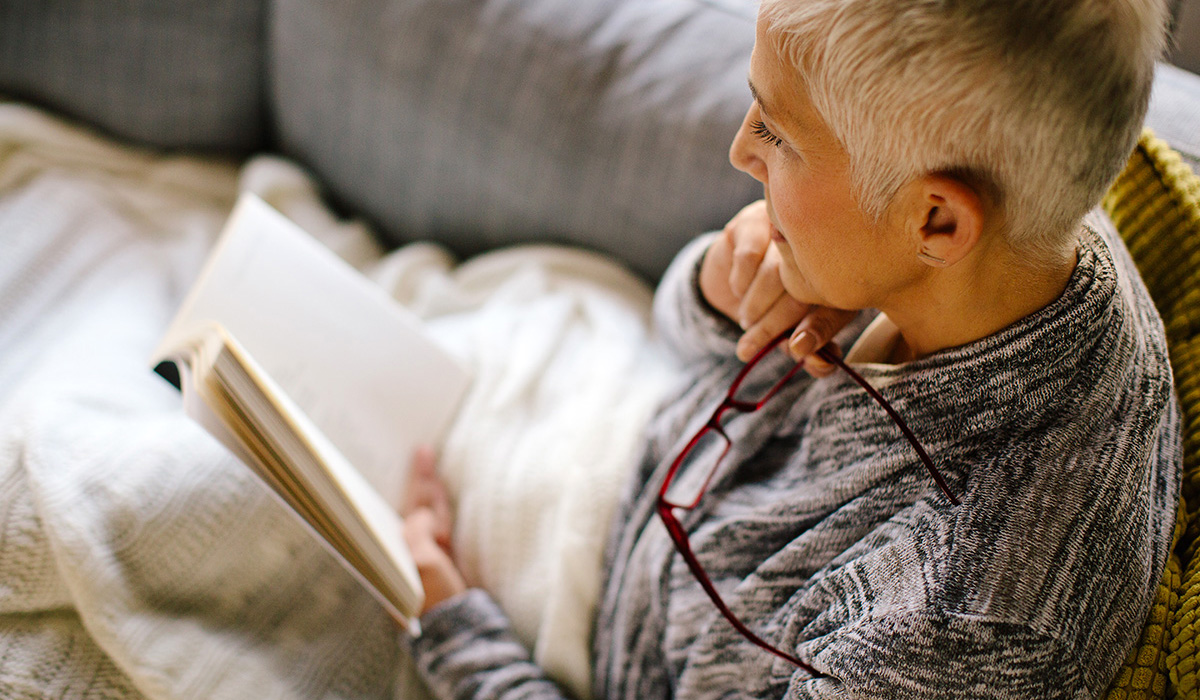 A person reading a book at home