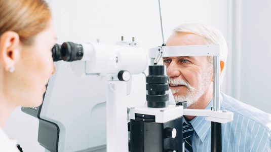Senior man examined by an ophthalmologist