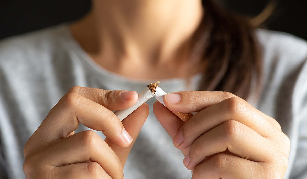 Close up of a woman's hand breaking cigarettes
