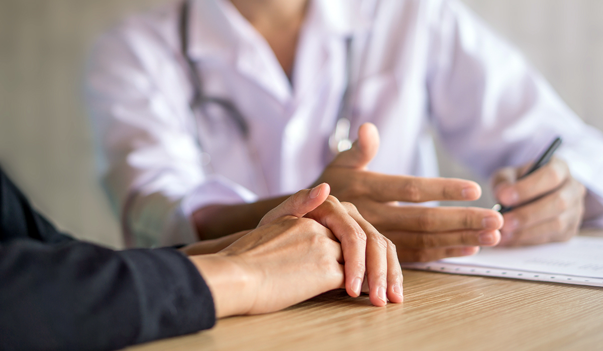 Doctor and patient talking in office discussing about exam at a hospital