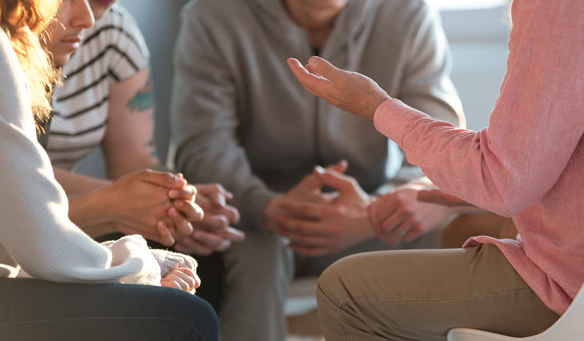 Therapist talking to a group of teenagers