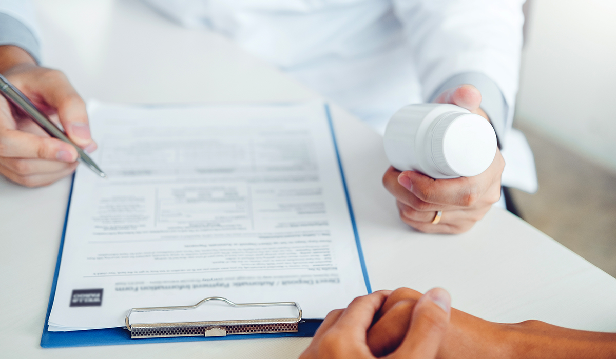 Doctor handing medication to patient