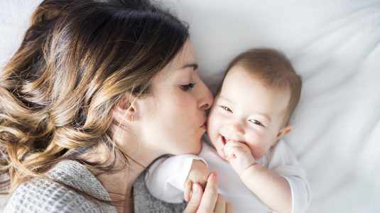 A Mother and baby on bed