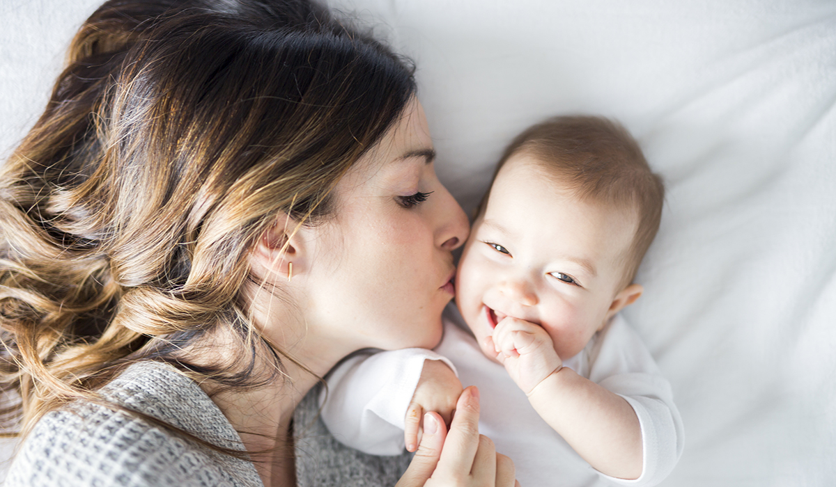 A Mother and baby on bed