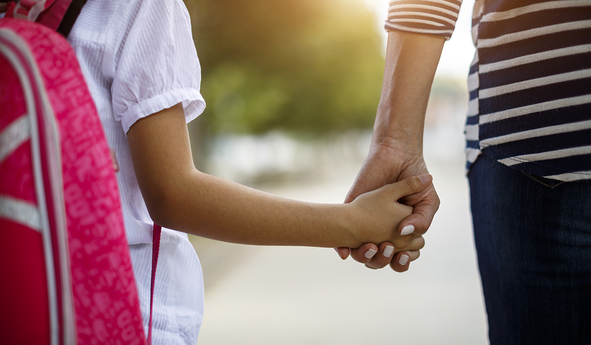 Mother and daughter holding hands