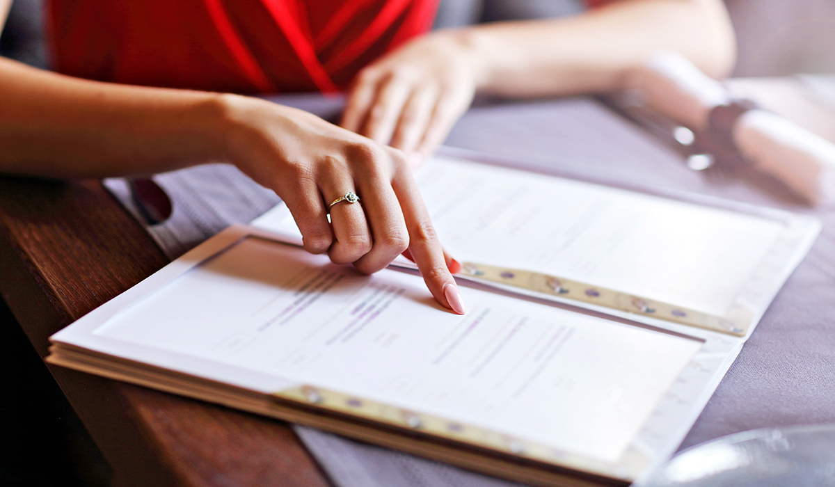 A person reading a menu at a restaurant