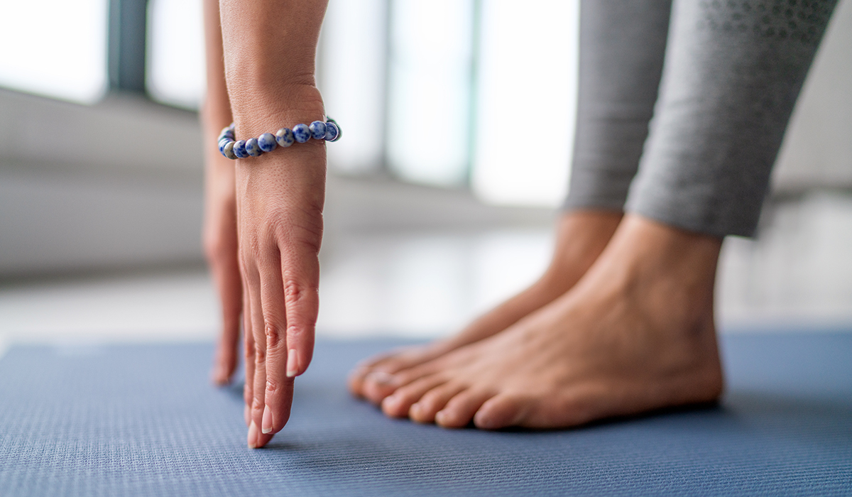 A person practicing yoga on a yoga mat