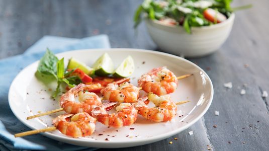 Grilled shrimp skewers and cucumber salad