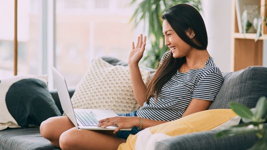 A person talking to her friend on laptop at home