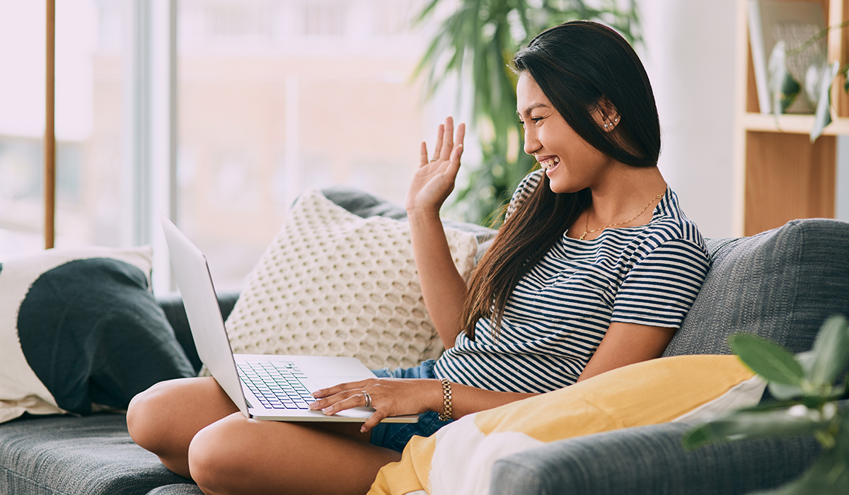 A person talking to her friend on laptop at home