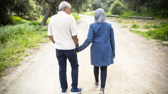 A senior couple taking a walk in the nature