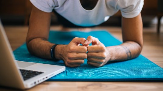 A man in a plank position on a yoga mat