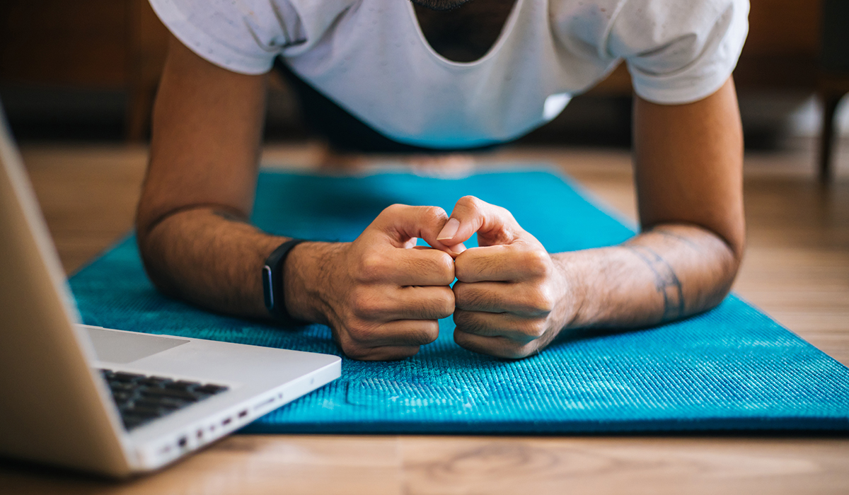 A man in a plank position on a yoga mat
