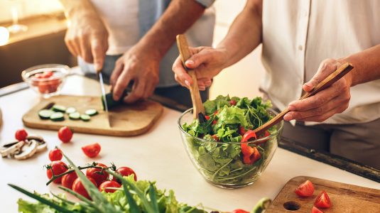 A senior couple preparing a healthy meal at home