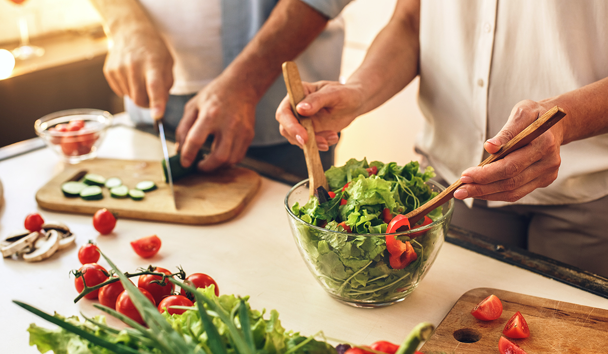 A senior couple preparing a healthy meal at home