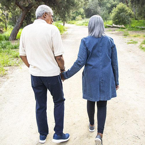 A senior couple taking a walk outdoors