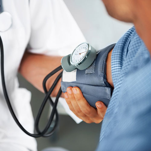 A doctor listening to his patient's heartbeat with a stethoscope