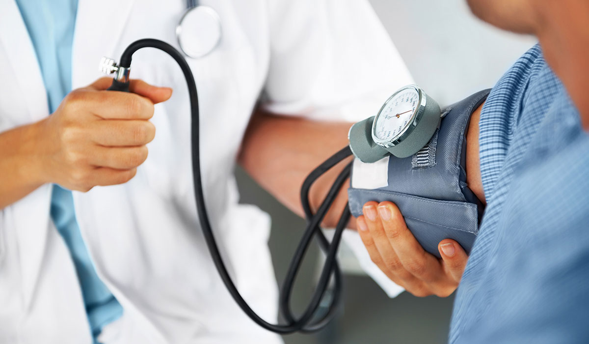 A doctor listening to his patient's heartbeat with a stethoscope