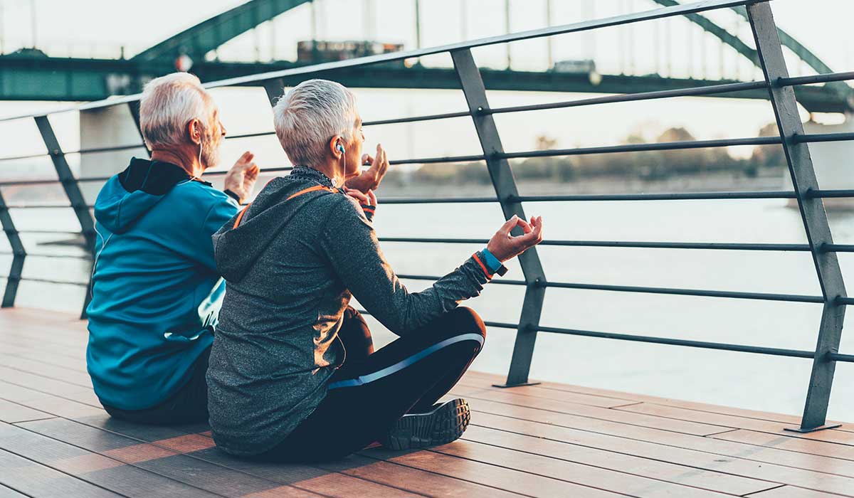 Two people meditating outdoors