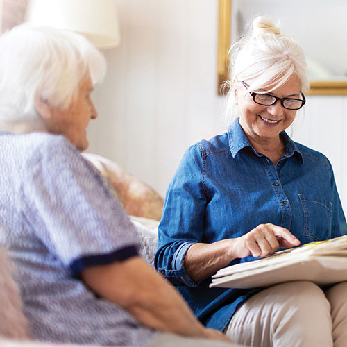 2 people looking through a photo album