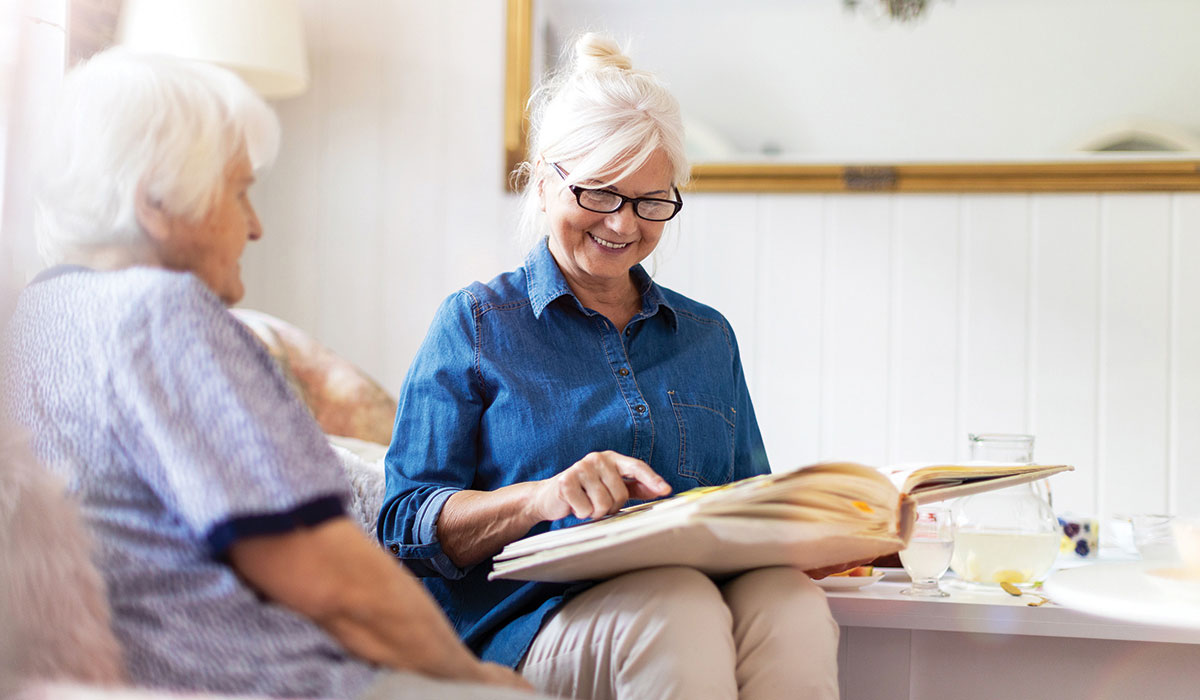 2 people looking through a photo album