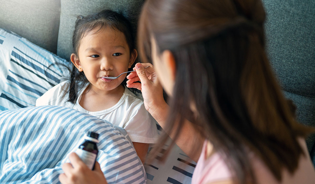A child getting her medicine