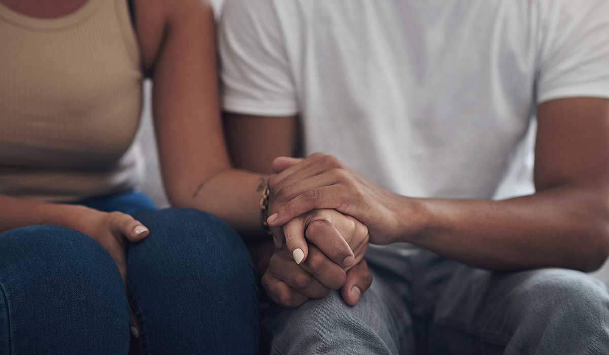 Holding hands to console a friend