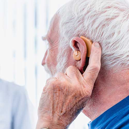 Elderly man with a hearing aid